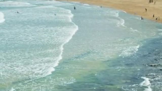 Ocean waves bursting on the shore of the coast