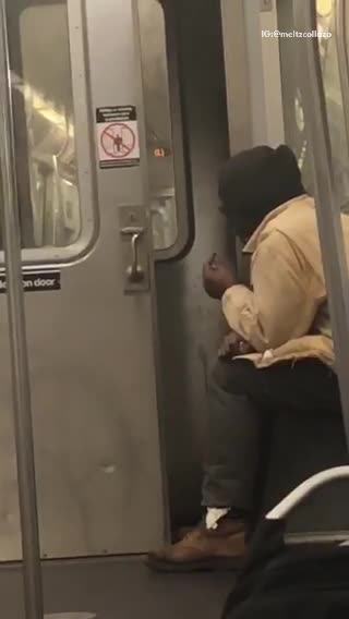 Man brown jacket smoking with subway doors open