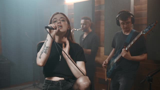 A Woman Singing With Her Music Band