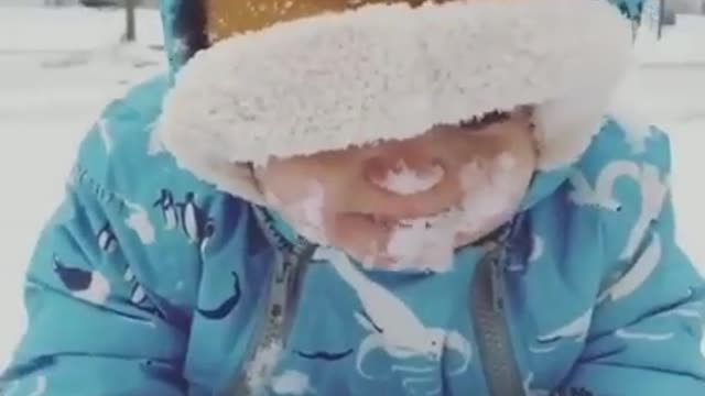 Cute Baby Eat the ice in snow fall