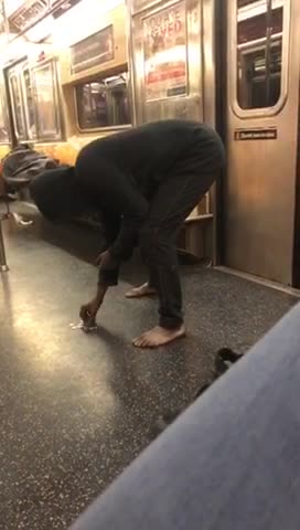 Barefoot woman counts change on subway floor