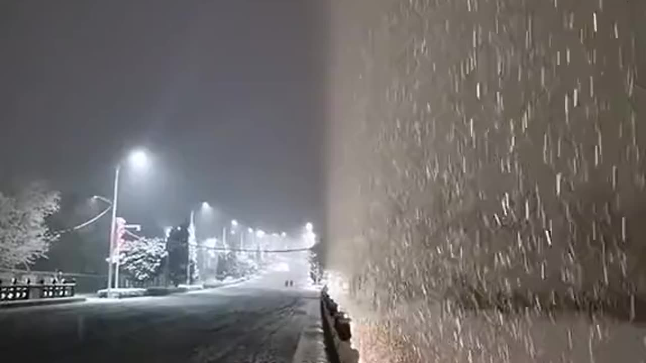 LIGHT ON FALLING SNOW LOOKS LIKE IT’S CREATING A PORTAL TO ANOTHER DIMENSION