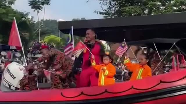 Boy accidentally points middle finger during parade