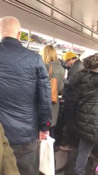 Two men wear the exact same outfit on subway train