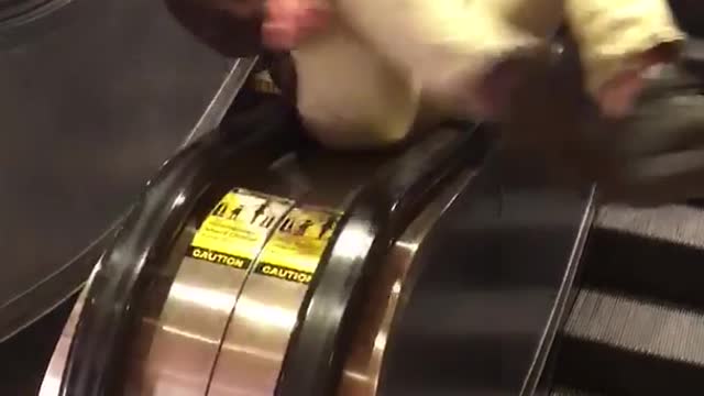 Guy rotating between escalators falls off