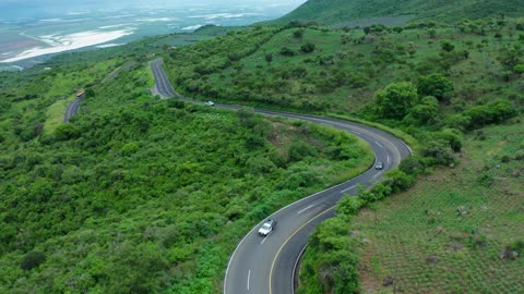 Curvy road on a tree covered hill Curvy road on a tree-covered hill