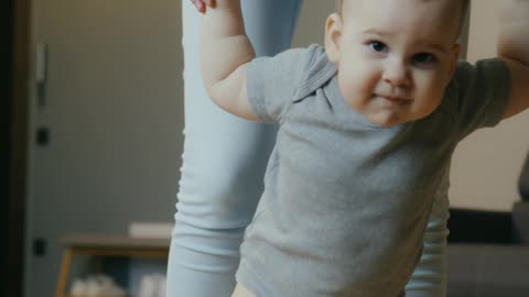 Mother Teaching Baby to Walk