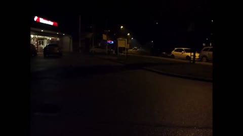 Firework blowing up dark parking lot