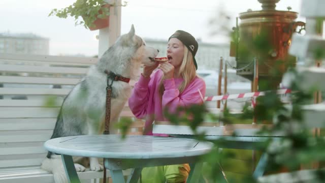 Dog And Girl Eating Pizza Together