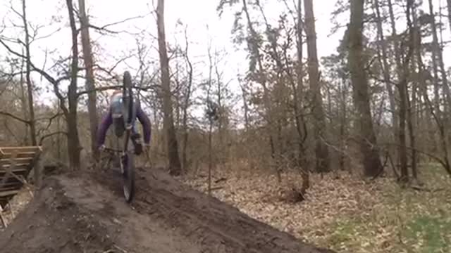 Slowmo guy attempts 360 bicycle spin off wooden ramp, faceplants