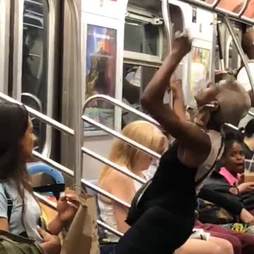 Girl dancing in front of subway train door