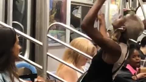 Girl dancing in front of subway train door