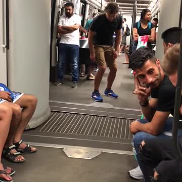 Guy pretending to ride middle of subway train