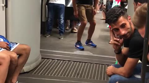 Guy pretending to ride middle of subway train