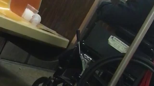 Man in wheelchair smokes cigarette inside subway