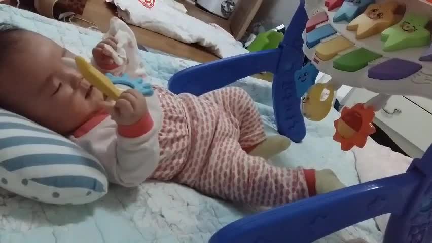 Putting teething toy in Baby's mouth Slowly