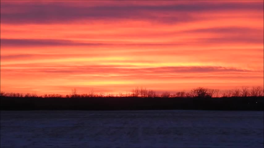Vibrant Colors Of Exhaust Clouds Spread Across the Prairie Sunset
