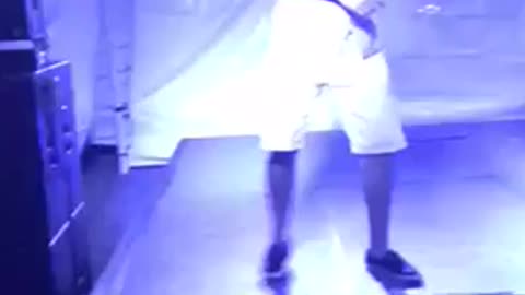 Guy drinking and dancing on stage