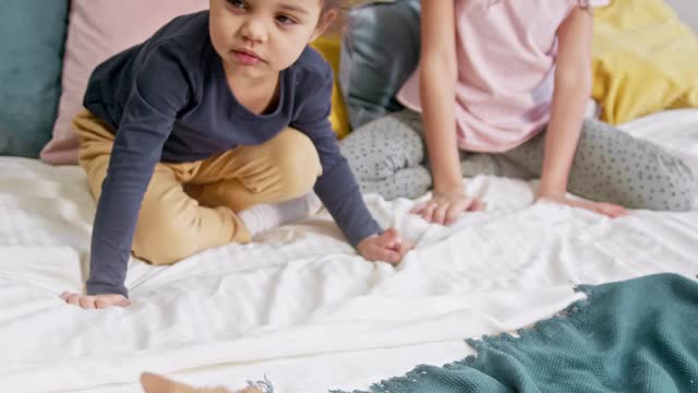 Kids Petting A Cat On The Bed