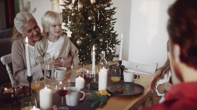 A Family Happily Gathered In The Dining Table