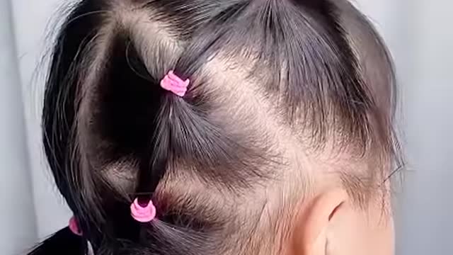 This little girl is happy with her hairstyles