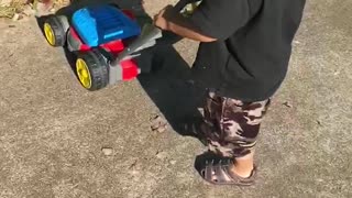 Toddler chasing his cat with the lawn mower