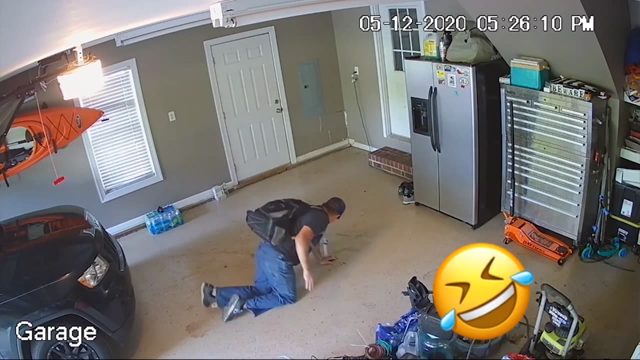 Man Slides on Oil Spill from Car While Walking in Garage