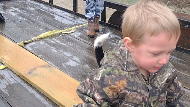Kids playing with beagle on a frozen trailer.