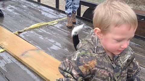 Kids playing with beagle on a frozen trailer.