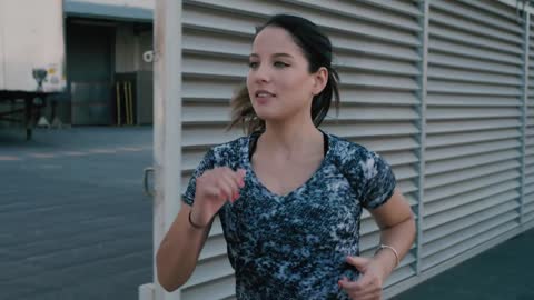 Woman runner on the sidewalk