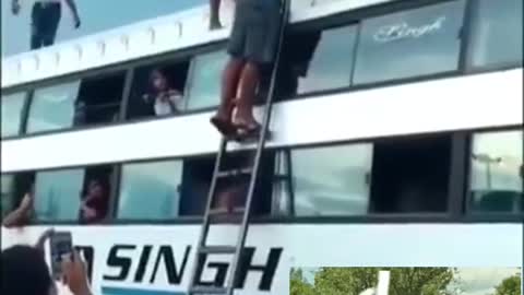 Carrying a motorcycle up a ladder using only his head..impressive