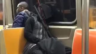 Man in all black asleep with swords around him