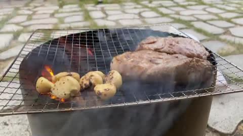 Grilling steak while camping