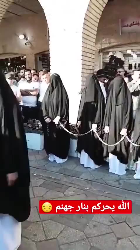 NO IDEA WHAT IS GOING ON HERE - BUT WOMEN ARE IN CHAINS?