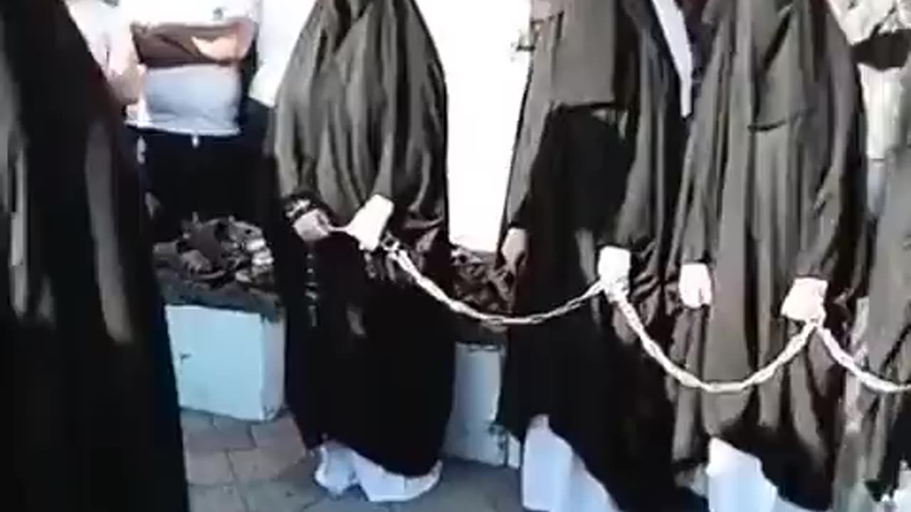 NO IDEA WHAT IS GOING ON HERE - BUT WOMEN ARE IN CHAINS?