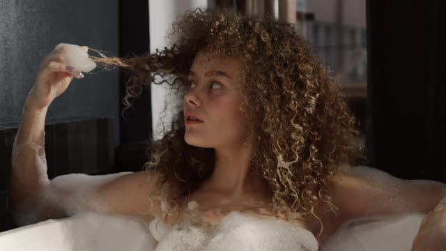 A Woman Relaxing Herself In A Bathtub