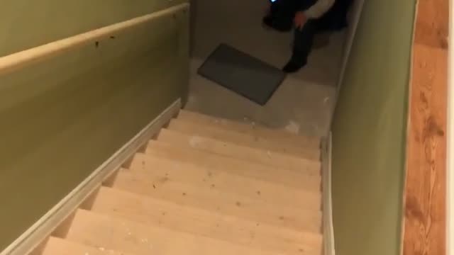Guy slides down stairs with towel cape