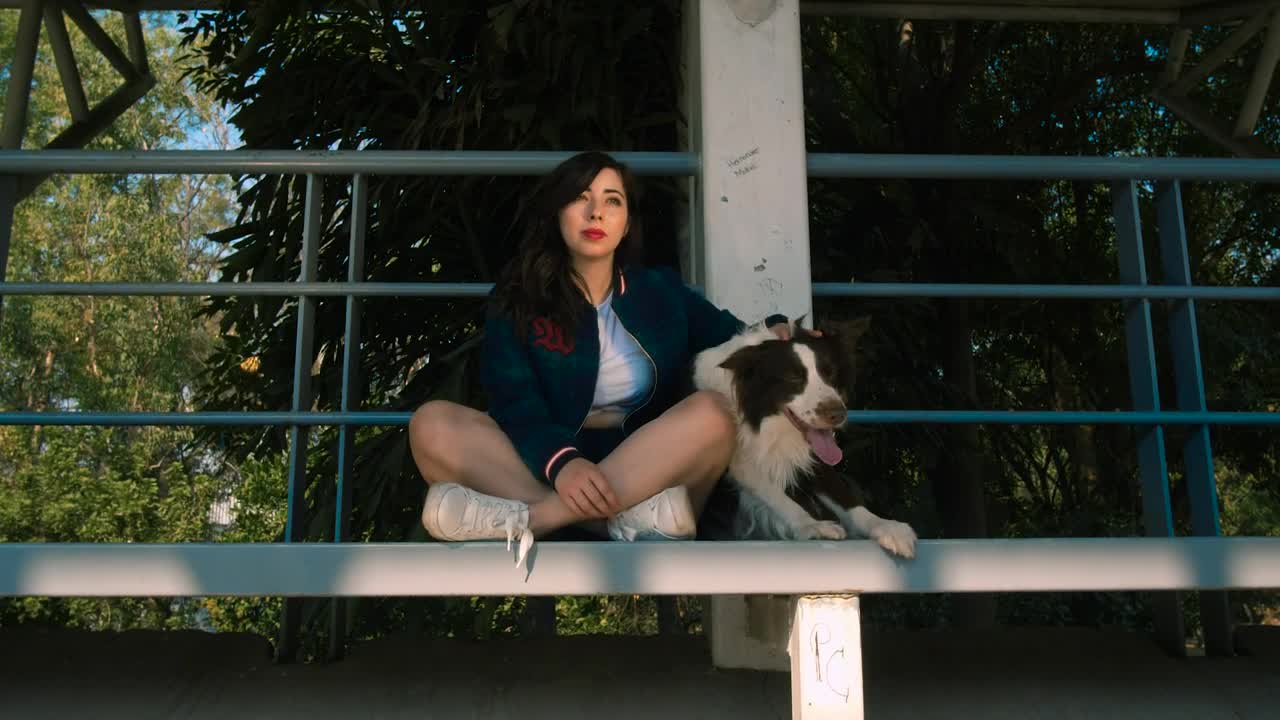 Woman with dog sitting on balcony