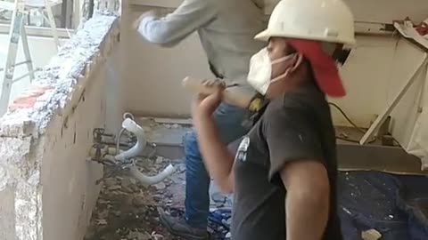 bricklayer breaking the wall rolling