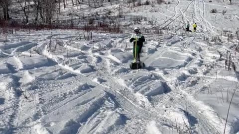 Electric Snowboards Cruise Up and Down Snowy Hill