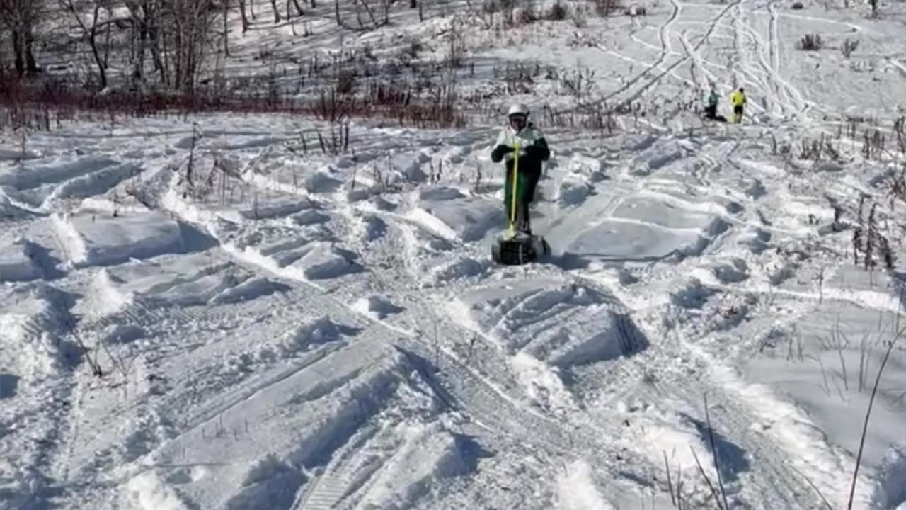 Electric Snowboards Cruise Up and Down Snowy Hill