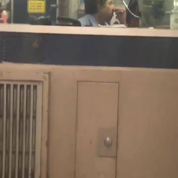 Guy picking nose in security booth subway