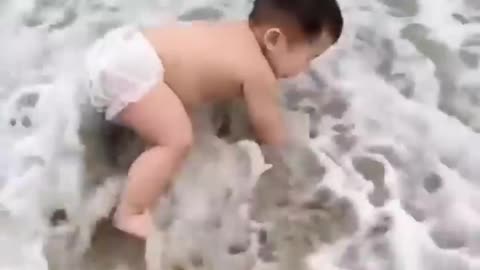 Cute baby reaction on the beach