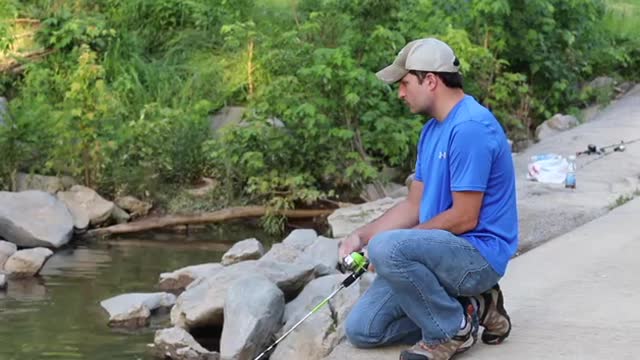 Man fishing in Creek Reeling