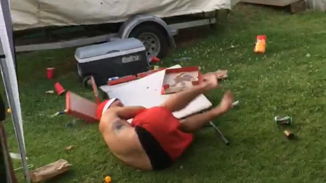 Shirtless santa hat slides across white table into another white table