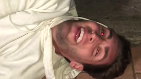 Guy falls off skateboard and hits his head on a yellow fire hydrant