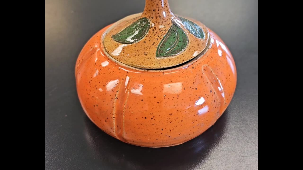 Making a pumpkin on the pottery wheel.