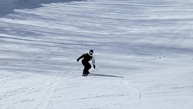 /a-person-practising-snowboarding