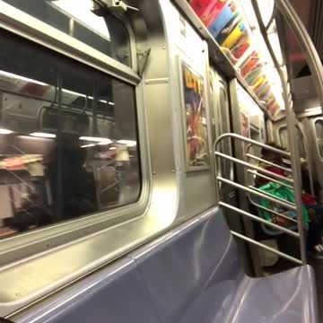 Woman sings loudly in subway train, recorder laughs