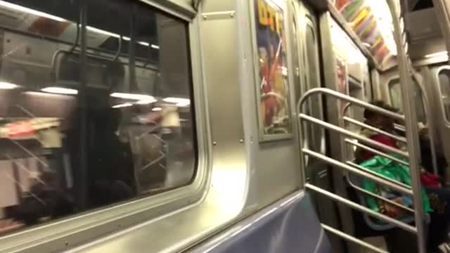 Woman sings loudly in subway train, recorder laughs